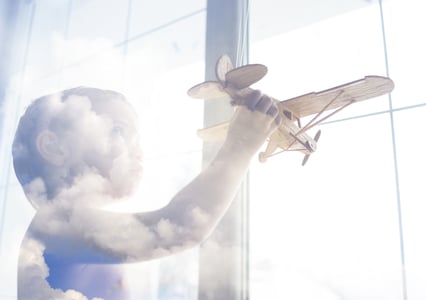 Portrait of child with airplane traveling toy in double exposure